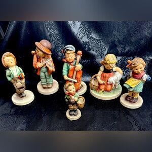 Hummel figurine collection with tin and stationary and collector’s plate.